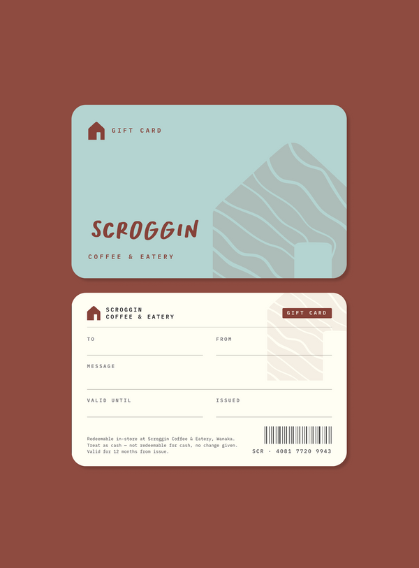 Front and back views of a Scroggin Coffee & Eatery gift card set against a solid dark reddish-brown background. The front features a light blue card with a stylized house graphic, and the back is cream with fields for recipient, message, sender, and validity, plus a barcode.
